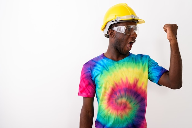 Studio shot of young black African man construction worker weari