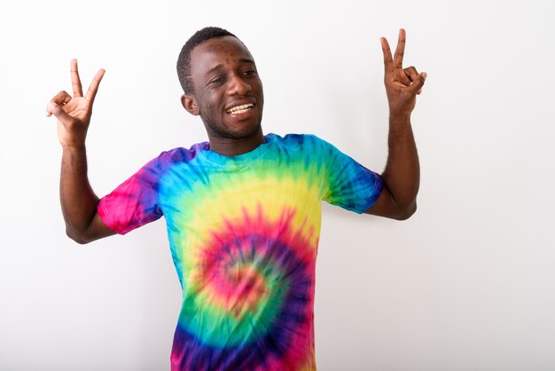 Studio shot of young black African man looking happy and making