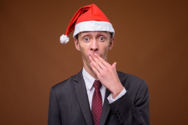 Studio shot of young businessman on brown