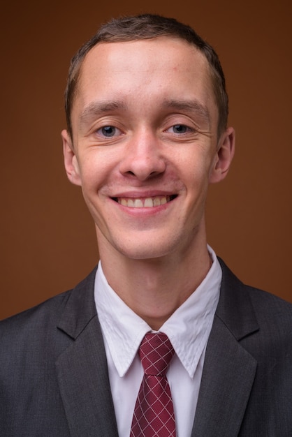 Studio shot of young businessman on brown