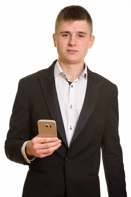 Studio shot of young businessman holding mobile phone