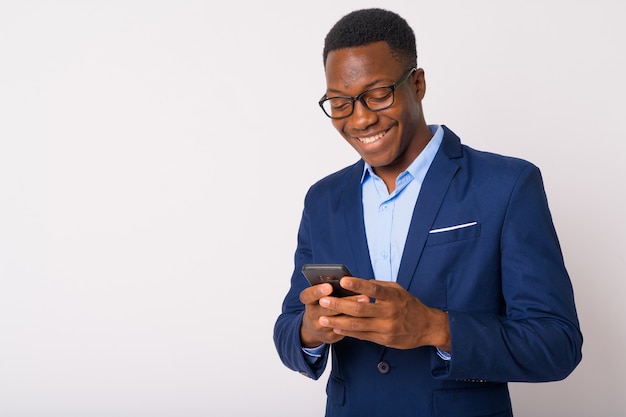 Studio shot of young handsome African businessman with Afro hair against white background