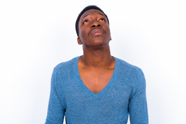 Studio shot of young handsome African man against white background