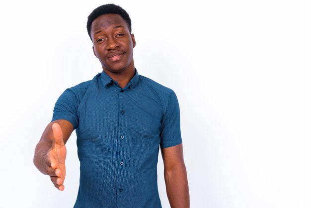 Studio shot of young handsome African man against white background