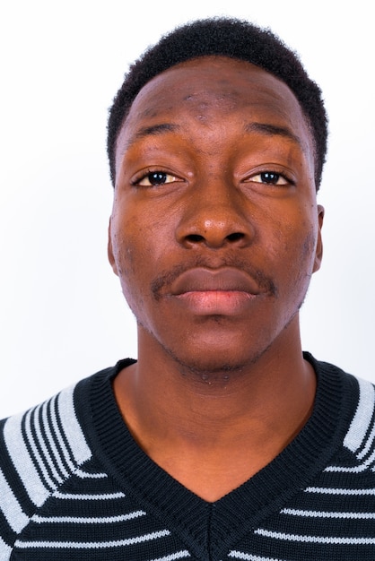 Studio shot of young handsome African man against white background