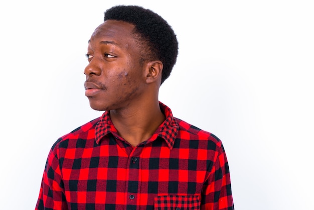 Studio shot of young handsome African man against white background