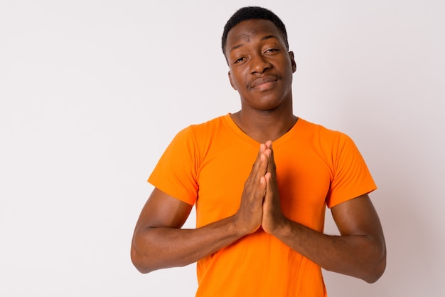 Studio shot of young handsome African man with Afro hair against white background