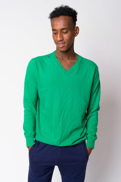 Studio shot of young handsome African man with Afro hair against white