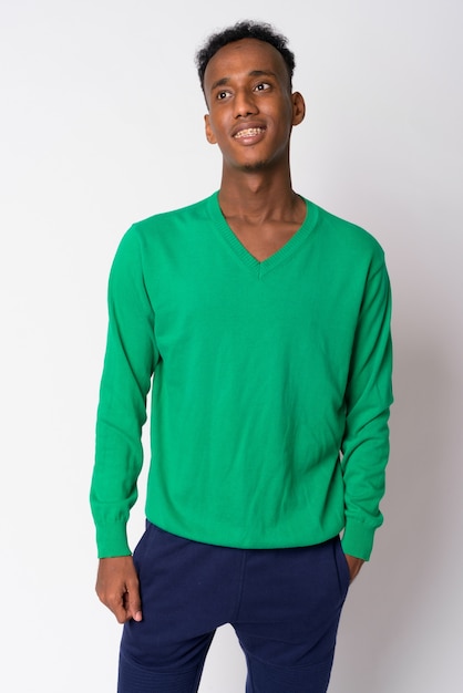 Studio shot of young handsome African man with Afro hair against white