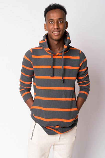 Studio shot of young handsome African man with Afro hair against white