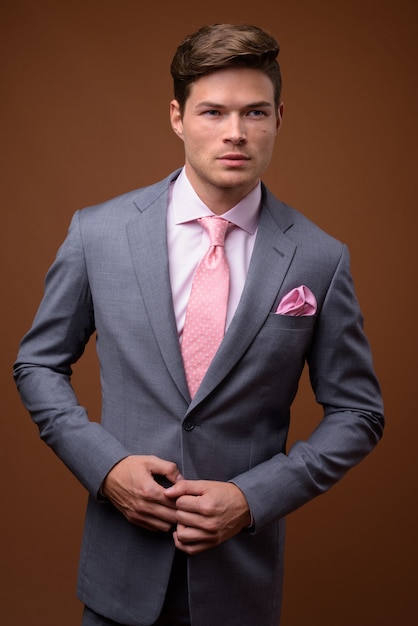 Studio shot of young handsome businessman in suit