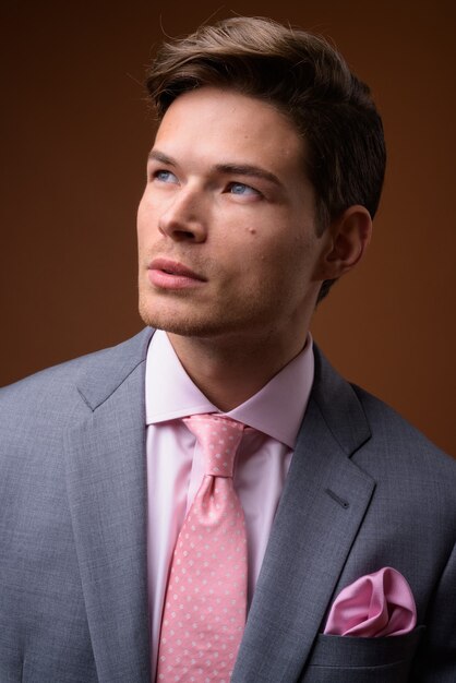 Studio shot of young handsome businessman in suit