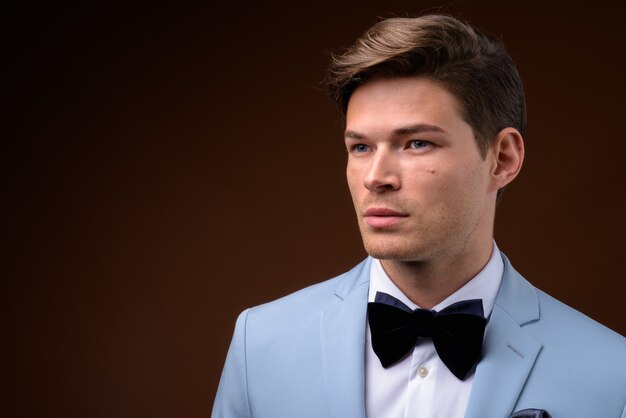 Studio shot of young handsome businessman in suit