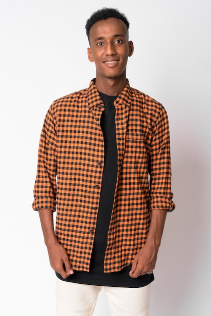 Studio shot of young handsome hipster man with Afro hair against white