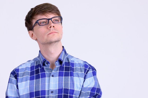 Studio shot of young handsome hipster man with eyeglasses against white