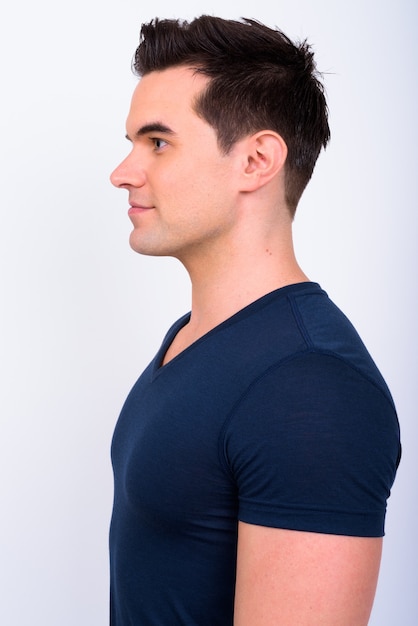 Studio shot of young handsome man against white background