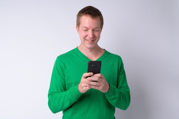 Studio shot of young handsome man against white background