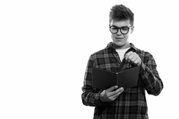 Studio shot of young handsome man reading book