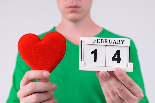 Studio shot of young handsome man ready for Valentine's day against white background