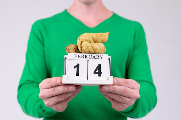 Studio shot of young handsome man ready for Valentine's day against white background