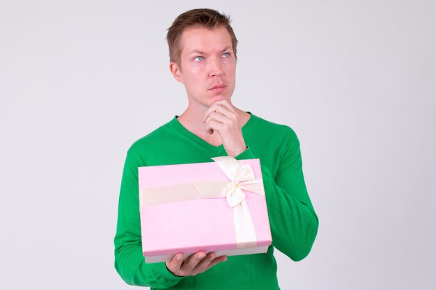 Studio shot of young handsome man ready for Valentine's day against white background