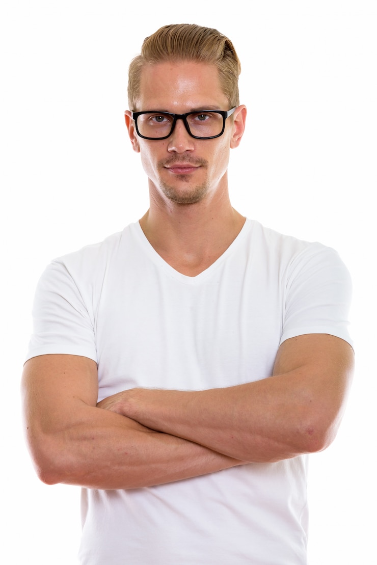 Photo studio shot of young handsome man wearing eyeglasses with arms crossed