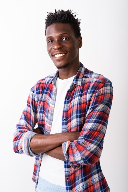 Studio shot of young happy black African man smiling