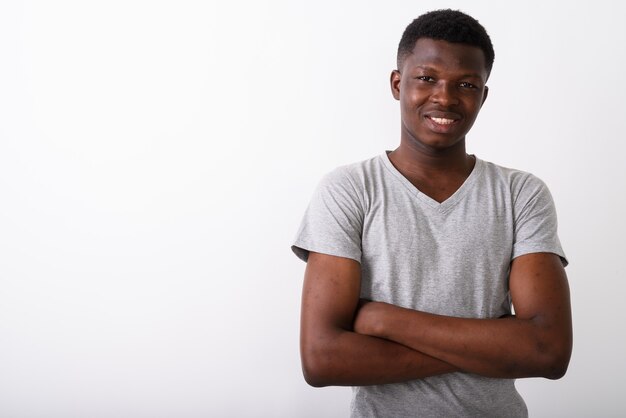 Studio shot of young happy black African man smiling