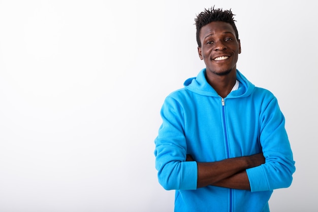 Studio shot of young happy black African man smiling