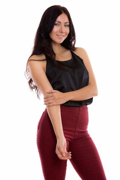 Studio shot of young happy businesswoman smiling and standing