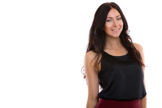 Studio shot of young happy businesswoman smiling