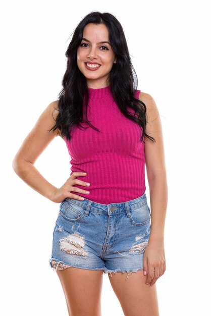 Studio shot of young happy Spanish woman smiling while posing