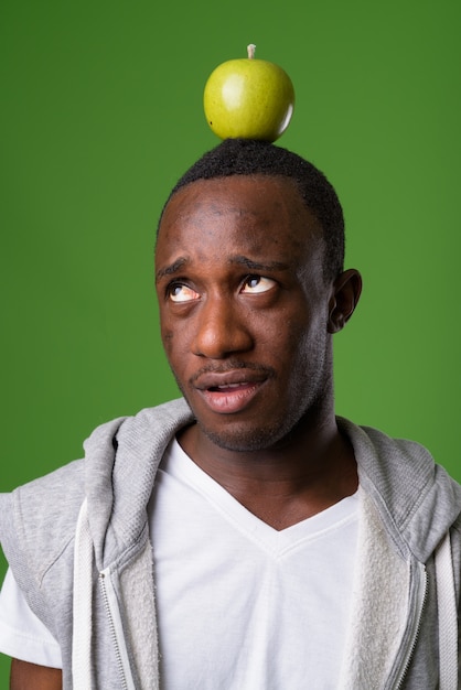 Studio shot of young man against green