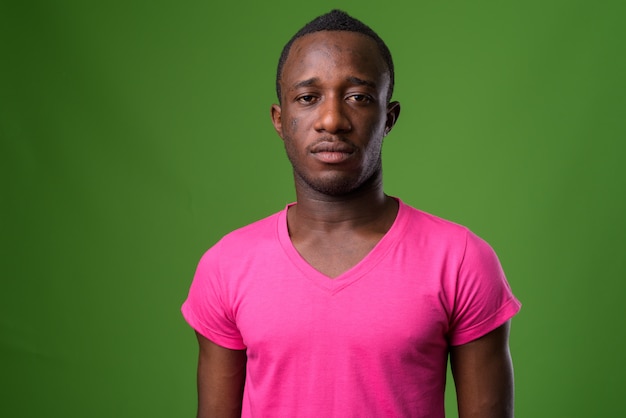 Studio shot of young man against green