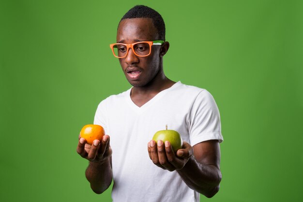 Studio shot of young man against green