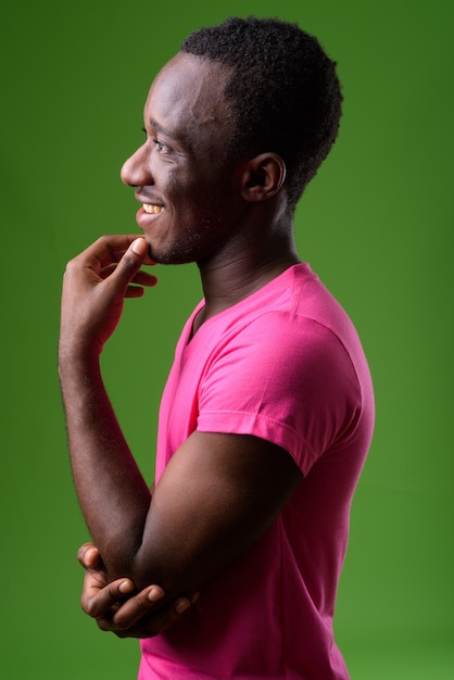 Studio shot of young man against green