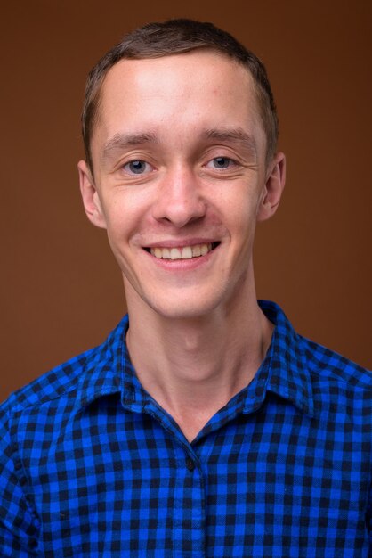 Studio shot of young man on brown