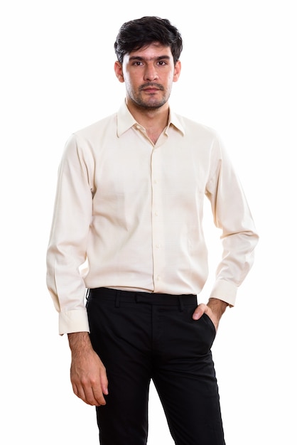 Studio shot of young Persian businessman standing