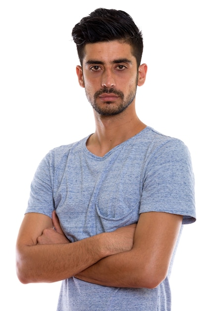 Studio shot of young Persian man with arms crossed