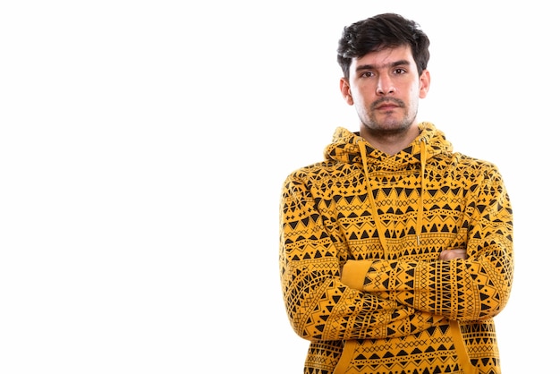 Studio shot of young Persian man with arms crossed