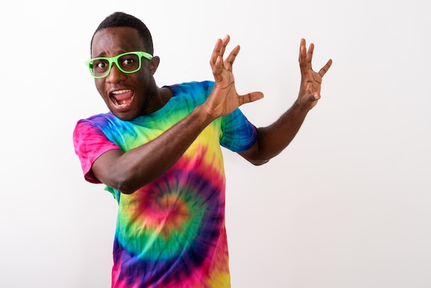 Studio shot of young scared black African man looking afraid and