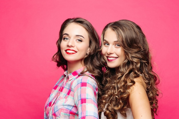 Studio view of beautiful girls with magnificent wavy hair and red lips