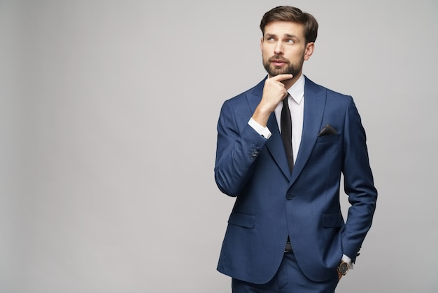 Studuo shot of thinking businessman wearing suit