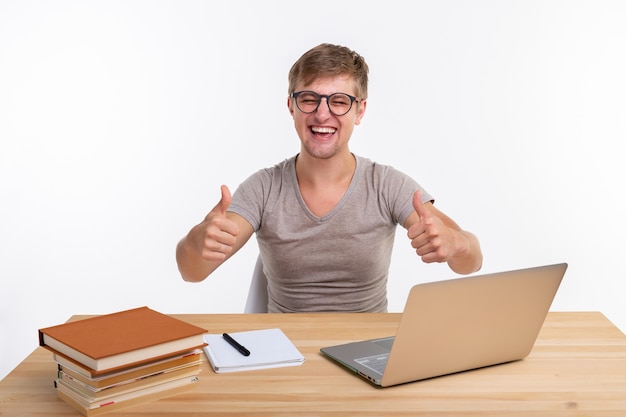 Study, education and emotions concept - male student doing exercises in laptop, looking amazed