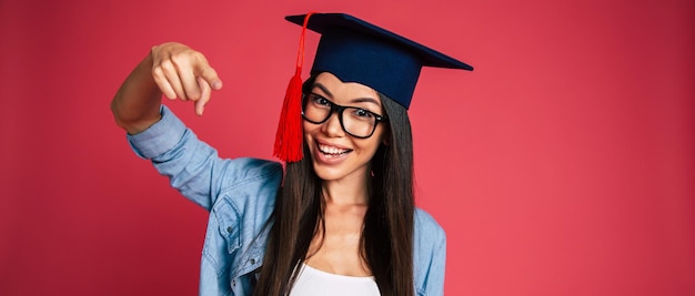 Study, education, university, college, graduate concept on\
banner. happy and excited portrait of young student girl in hat of\
graduation isolated