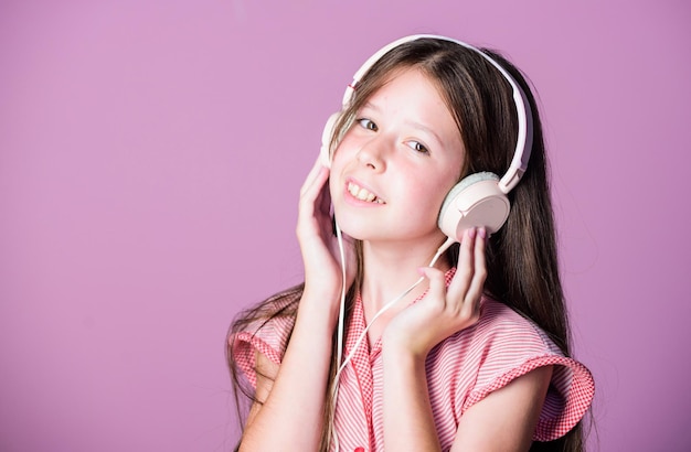 Study language home schooling small girl pupil in headphones self education Mp3 player girl listen to music Audio book back to school child study online E learning with ebook