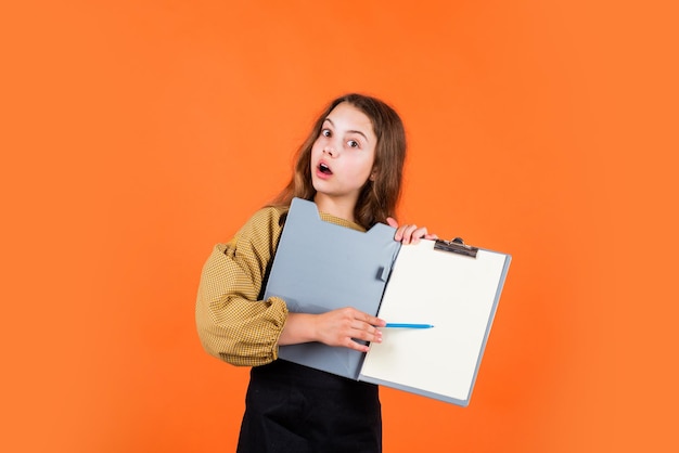 Study and work surprised teen girl with document folder happy childhood