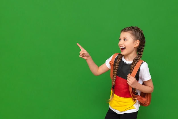 Studying abroad learning German a little girl with textbooks and a briefcase on an isolated background