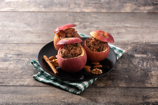 Stuffed apples baked with nuts on wooden table