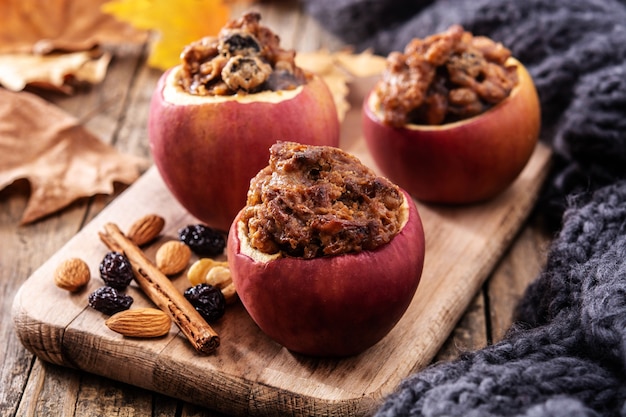 Stuffed apples baked with nuts on a wooden table